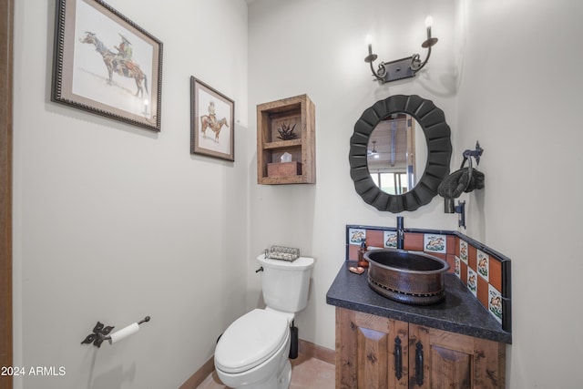 bathroom with tile patterned flooring, vanity, and toilet