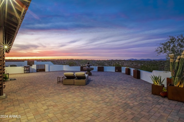 patio terrace at dusk featuring grilling area