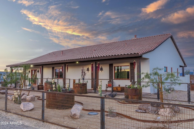 view of back house at dusk