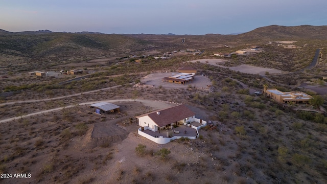 aerial view at dusk featuring a mountain view