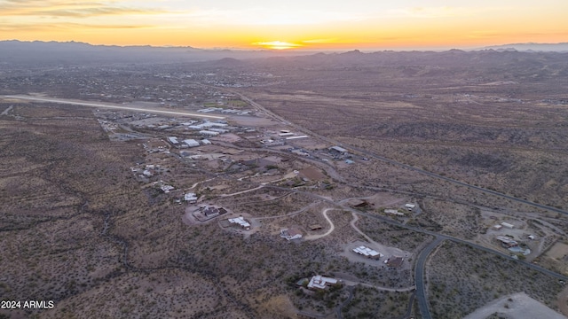 aerial view at dusk featuring a mountain view