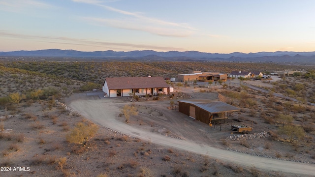 aerial view at dusk featuring a mountain view