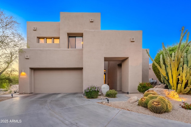 10772 E Running Deer Trl, Scottsdale, AZ 85262 - pueblo-style house featuring a garage, stucco siding, and concrete driveway