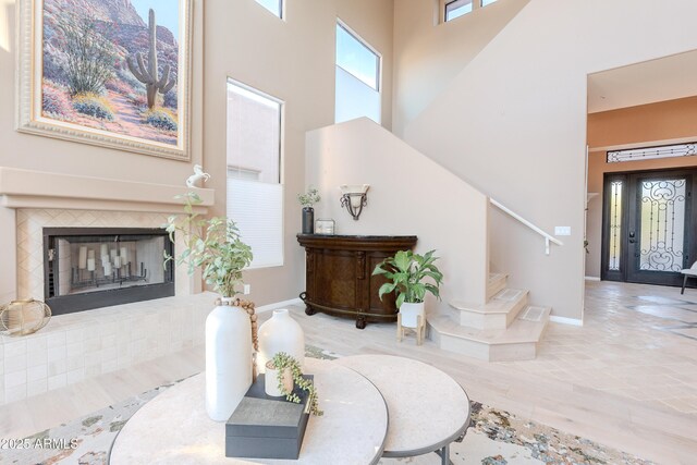 10772 E Running Deer Trl, Scottsdale, AZ 85262 - entrance foyer featuring a high ceiling, stairway, a fireplace with raised hearth, baseboards, and wood finished floors