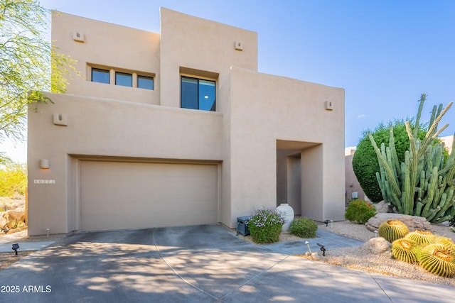 10772 E Running Deer Trl, Scottsdale, AZ 85262 - pueblo-style house featuring a garage, stucco siding, and driveway