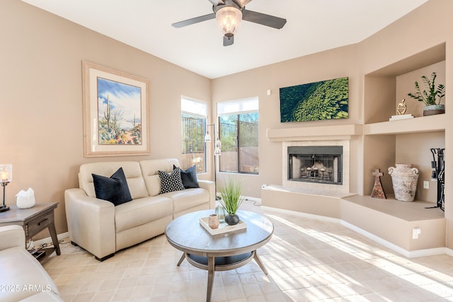 10772 E Running Deer Trl, Scottsdale, AZ 85262 - living area with a ceiling fan, a fireplace with raised hearth, and baseboards