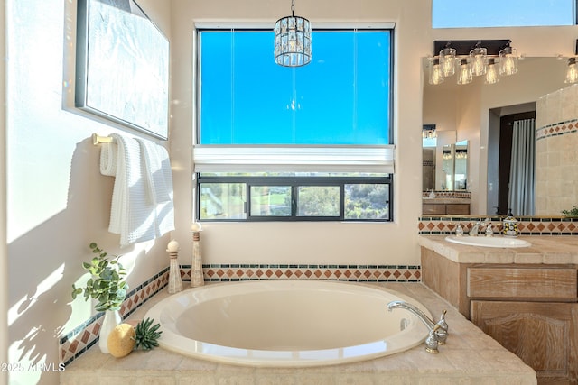 10772 E Running Deer Trl, Scottsdale, AZ 85262 - full bath featuring a garden tub, vanity, and a chandelier