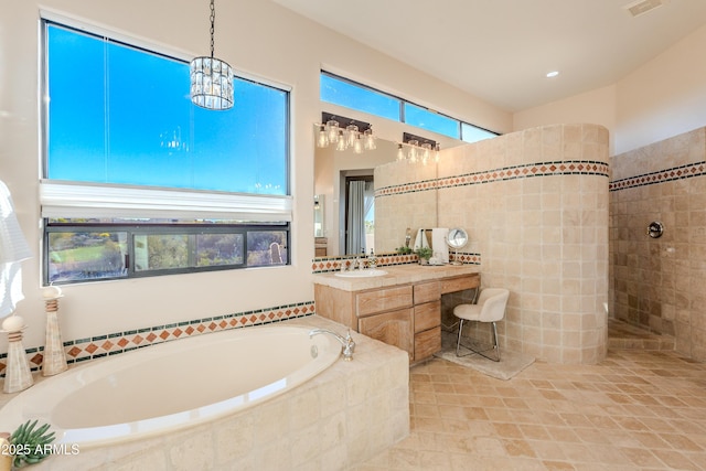 10772 E Running Deer Trl, Scottsdale, AZ 85262 - bathroom with a garden tub, tile walls, a walk in shower, vanity, and tile patterned flooring