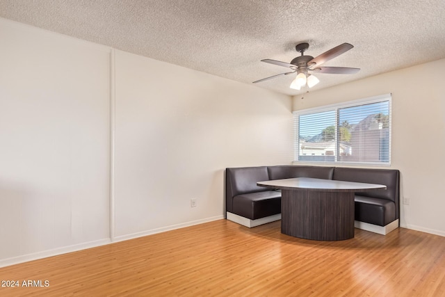 sitting room featuring a textured ceiling, light wood-type flooring, and ceiling fan