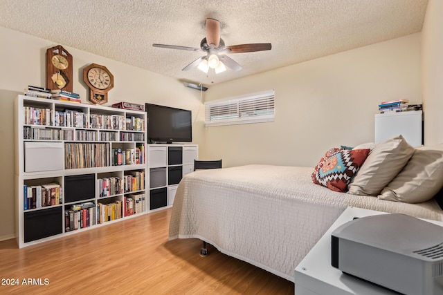 bedroom featuring a textured ceiling, hardwood / wood-style flooring, and ceiling fan