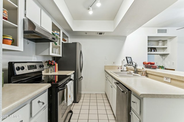 kitchen with sink, white cabinetry, light tile patterned floors, and appliances with stainless steel finishes