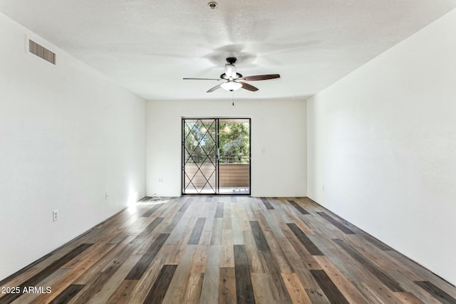 empty room with hardwood / wood-style floors and ceiling fan