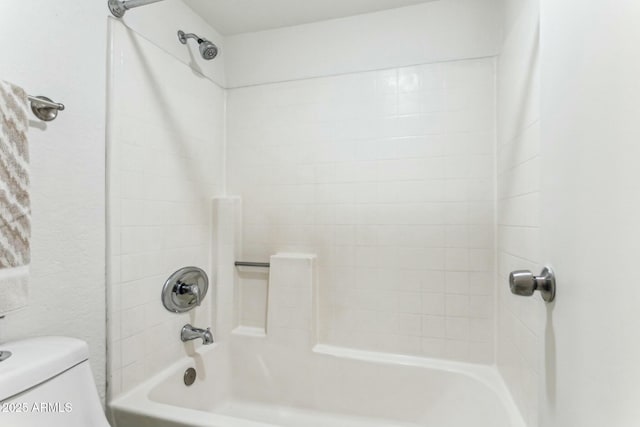 bathroom featuring bathing tub / shower combination and toilet