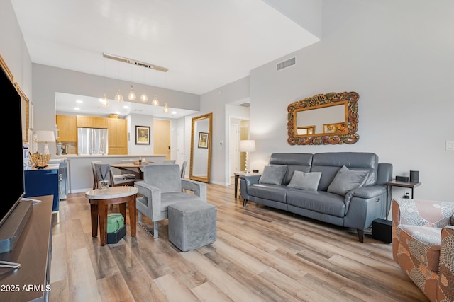 living room featuring visible vents and light wood-type flooring