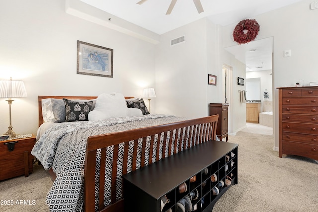 bedroom with visible vents, carpet floors, ensuite bathroom, and a ceiling fan