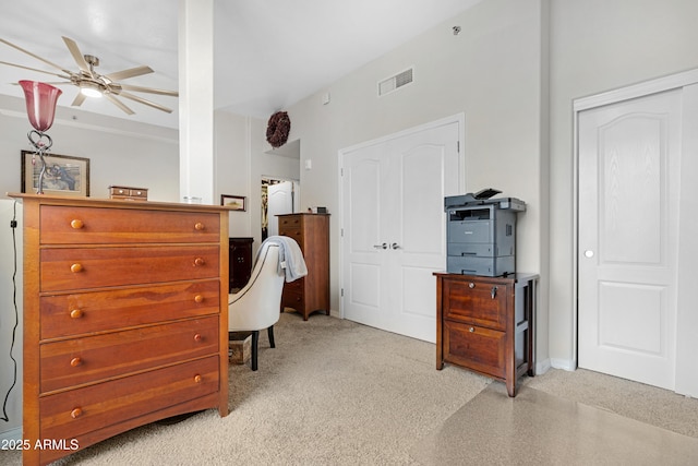 bedroom featuring visible vents, light colored carpet, and ceiling fan