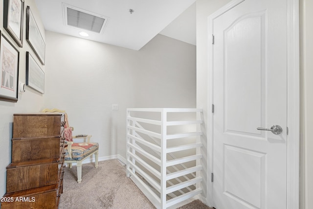 interior space featuring visible vents, baseboards, and carpet flooring