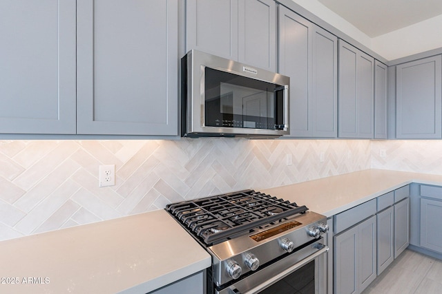 kitchen with stainless steel appliances and tasteful backsplash