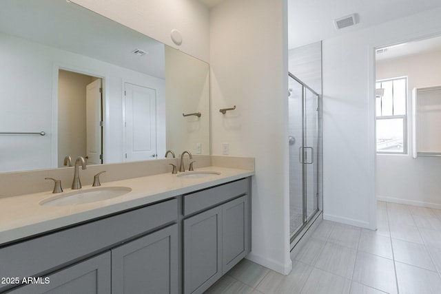 bathroom with vanity and a shower with shower door