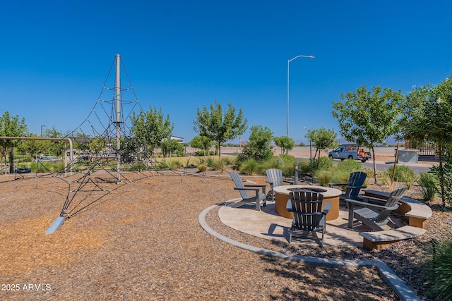 view of yard featuring a patio and an outdoor fire pit