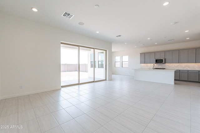 unfurnished living room with light tile patterned flooring