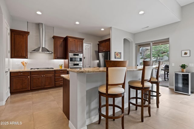 1385 Ridgewood Dr, Prescott, AZ 86305 - kitchen with wall chimney range hood, appliances with stainless steel finishes, beverage cooler, decorative backsplash, and recessed lighting