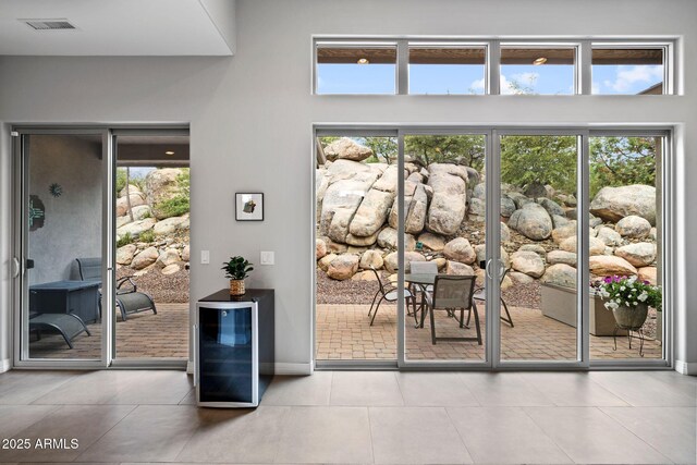 1385 Ridgewood Dr, Prescott, AZ 86305 - doorway to outside featuring beverage cooler, plenty of natural light, and baseboards