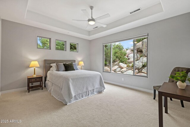 1385 Ridgewood Dr, Prescott, AZ 86305 - bedroom with a tray ceiling, light carpet, baseboards, and a ceiling fan