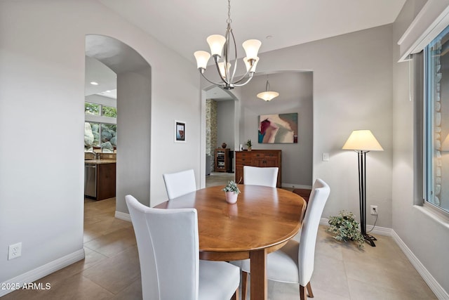 1385 Ridgewood Dr, Prescott, AZ 86305 - dining area with a chandelier, arched walkways, light tile patterned flooring, and baseboards