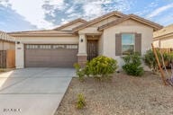 view of front of property with a garage and concrete driveway