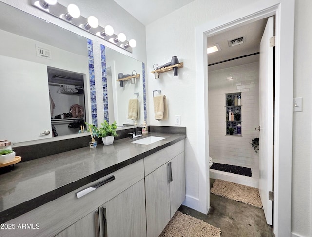 4050 E Cactus Rd Unit 107, Phoenix, AZ 85032 - full bath featuring vanity, a tile shower, concrete floors, and a spacious closet