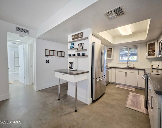 4050 E Cactus Rd Unit 107, Phoenix, AZ 85032 - kitchen featuring stainless steel appliances, dark countertops, concrete flooring, glass insert cabinets, and open shelves