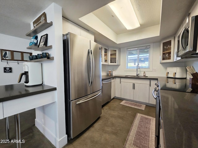 4050 E Cactus Rd Unit 107, Phoenix, AZ 85032 - kitchen featuring stainless steel appliances, dark countertops, open shelves, finished concrete flooring, and glass insert cabinets