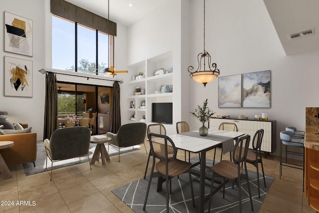 tiled dining space with built in features and high vaulted ceiling