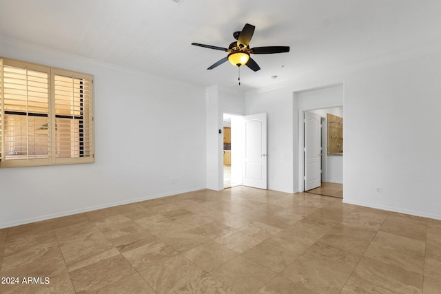 unfurnished room featuring ceiling fan and crown molding