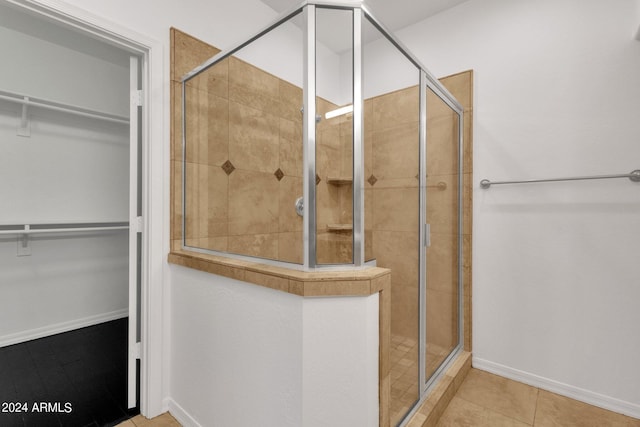 bathroom with tile patterned flooring and a shower with door