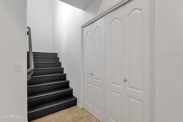 staircase featuring tile patterned floors