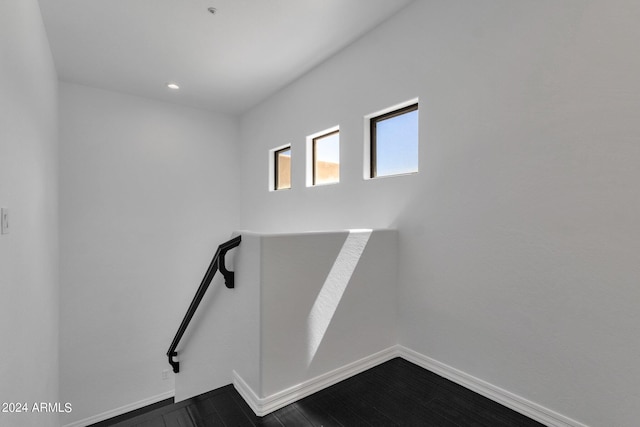 staircase with hardwood / wood-style floors