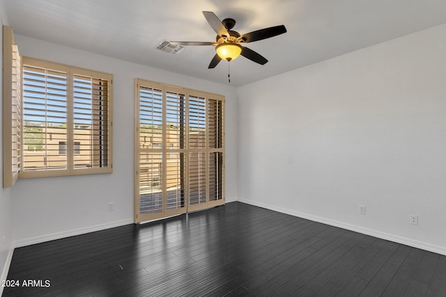 unfurnished room featuring ceiling fan and dark wood-type flooring