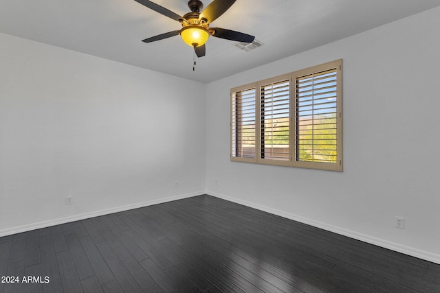 empty room featuring dark hardwood / wood-style flooring and ceiling fan