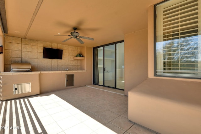 view of patio featuring area for grilling and ceiling fan