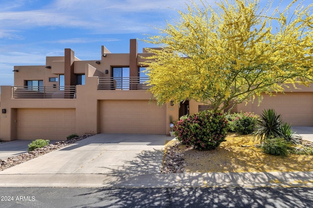 view of front of home featuring a balcony and a garage