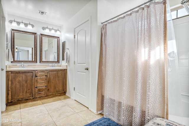 bathroom featuring tile patterned flooring and vanity