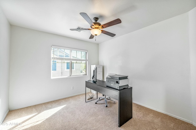 carpeted office space with ceiling fan