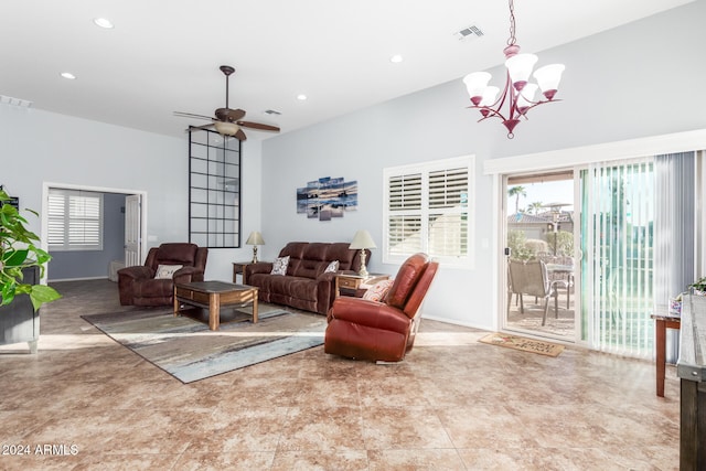 living room featuring ceiling fan with notable chandelier