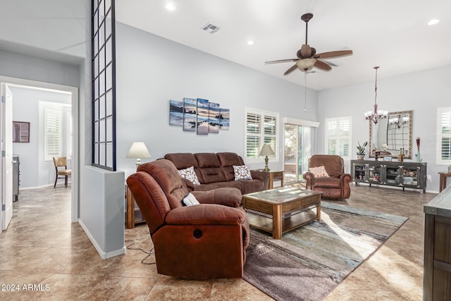 living room featuring light tile patterned floors and ceiling fan with notable chandelier