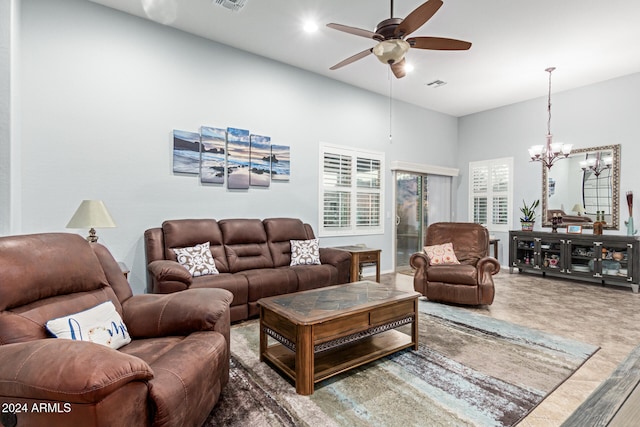 living room featuring wood-type flooring and ceiling fan with notable chandelier