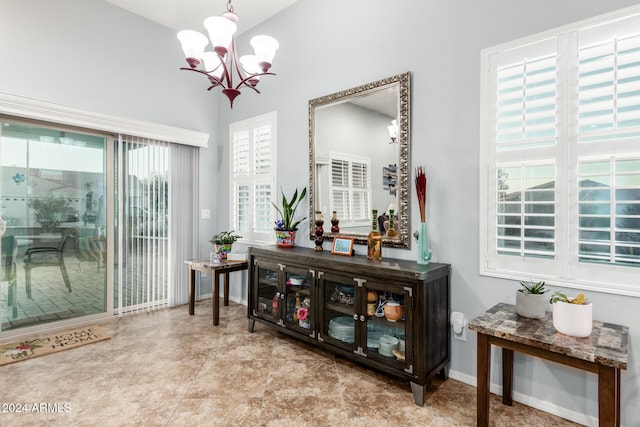 interior space featuring plenty of natural light and an inviting chandelier