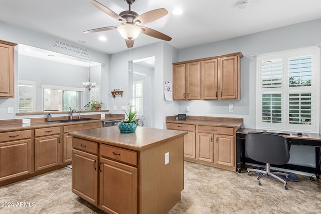 kitchen featuring plenty of natural light, a center island, sink, and decorative light fixtures