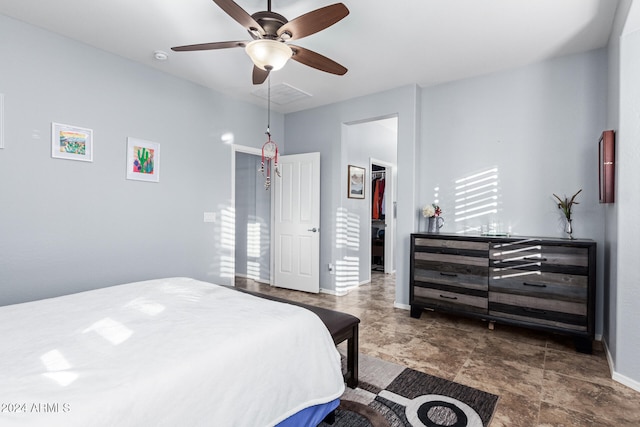 bedroom with ceiling fan and a spacious closet